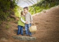 Two Children with Basket Hugging Outside on Steps