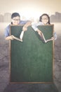 Two children with book and chalkboard Royalty Free Stock Photo