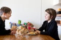 Two children, boy brothers, fighting at home with easter eggs in the morning