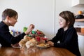 Two children, boy brothers, fighting at home with easter eggs in the morning