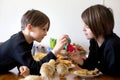 Two children, boy brothers, fighting at home with easter eggs in the morning