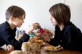 Two children, boy brothers, fighting at home with easter eggs in the morning