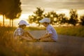 Two children, boy brothers, having fun outdoors with toy cars Royalty Free Stock Photo