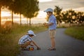 Two children, boy brothers, having fun outdoors with toy cars Royalty Free Stock Photo