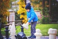 Two children, boy brothers, playing chess with huge figures in t Royalty Free Stock Photo