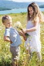 Two children boy and girl at camomile field Royalty Free Stock Photo