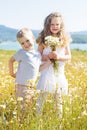 Two children boy and girl at camomile field Royalty Free Stock Photo