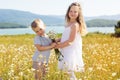 Two children boy and girl at camomile field Royalty Free Stock Photo