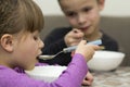 Two children boy and girl eating soup Royalty Free Stock Photo