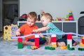 Two children boy play together with toys in interior of children& x27;s room.. Royalty Free Stock Photo