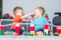 Two children boy play together with toys in interior of children's room.. Royalty Free Stock Photo