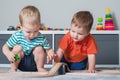 Two children boy play together with toys in interior of children's room.. Royalty Free Stock Photo