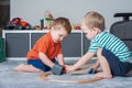 Two children boy play together with toys in interior of children's room.. Royalty Free Stock Photo