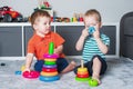Two children boy play together with toys in interior of children's room.. Royalty Free Stock Photo