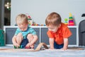 Two children boy play together with toys in interior of children`s room Royalty Free Stock Photo