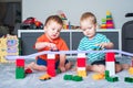 Two children boy play together with toys in interior of children`s room Royalty Free Stock Photo