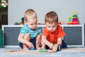 Two children boy play together with toys in interior of children's room.. Royalty Free Stock Photo