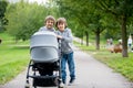Two children, boys, pushing stroller with little baby Royalty Free Stock Photo