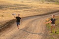 Two children, boys, run along a dirt road and launch toy airplanes Royalty Free Stock Photo