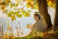 Two children, boys, sitting on the edge of a lake on a sunny autumn afternoon Royalty Free Stock Photo