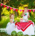 Two children brother and sister eat sweet cupcakes on beautiful decorated picnic. Hungry kids boy and girl eating outdoors. What Royalty Free Stock Photo