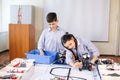 Two children, brother with sister enaging in their hobby-constructing robot toys Royalty Free Stock Photo