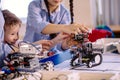 Two children, brother with sister enaging in their hobby-constructing robot toys Royalty Free Stock Photo
