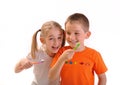 Two children brush their teeth isolated on white