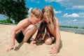 Two children build sandcastle on beach. Boy and girl play with sand on sea shore Royalty Free Stock Photo