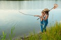 Two children with a butterfly net near the river