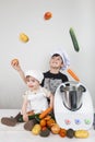 Two children cooking with a futuristic machine Royalty Free Stock Photo