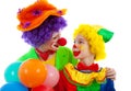 Two children dressed as colorful funny clown