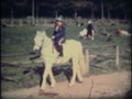 Two children dressed as cowboys on horses 1964