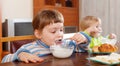 Two children eating dairy breakfast Royalty Free Stock Photo