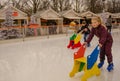 Two children enjoy ice skating in Tuileries Garden in Paris