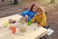 Two children enjoying a picnic outside in the forest Royalty Free Stock Photo