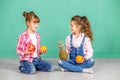 Two children with fruit, orange, pineapple and pomegranate. Girl