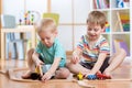 Two children little boys playing role game in daycare