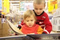 Two children look book in store Royalty Free Stock Photo