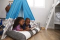 Two Children Lying In Tent In Playroom With Digital Tablet Royalty Free Stock Photo