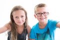 two children make photo selfie with smartphone on white background wall