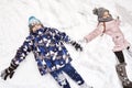 Two children making snow angels Royalty Free Stock Photo
