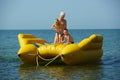 Two children with mom on the dinghy sailing at sea in summer Royalty Free Stock Photo