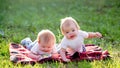 Two children of 6 months crawl on a blanket