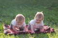 Two children of 6 months crawl a blanket