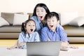 Two children and mother shocked with a laptop Royalty Free Stock Photo