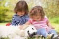 Two Children Petting Family Dog In Summer Field