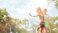 Two children play with sprinkling water in summer garden Royalty Free Stock Photo