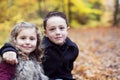 Children playing in beautiful autumn park on cold sunny fall day. Royalty Free Stock Photo