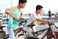 Two children playing bikes on the beach Royalty Free Stock Photo